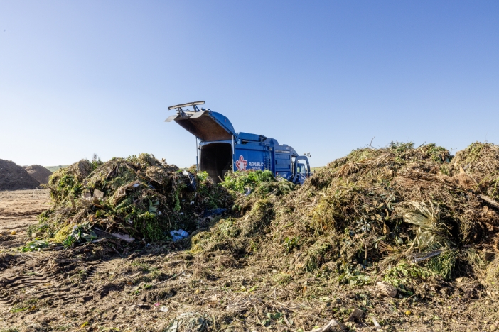 An organics truck drops off a load of feedstock collected from residential homes.